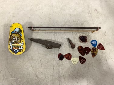 Vintage kazoos, guitar pics, tin toy, and more