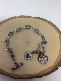 Silvertone charm bracelet with hearts(7in.long)