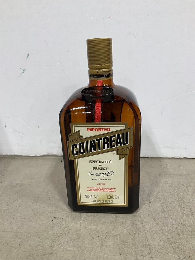 1970's/80's Cointreau(750mL): Any contents in bottle is Free; You are bidding on the bottle & unbroken tax stamp