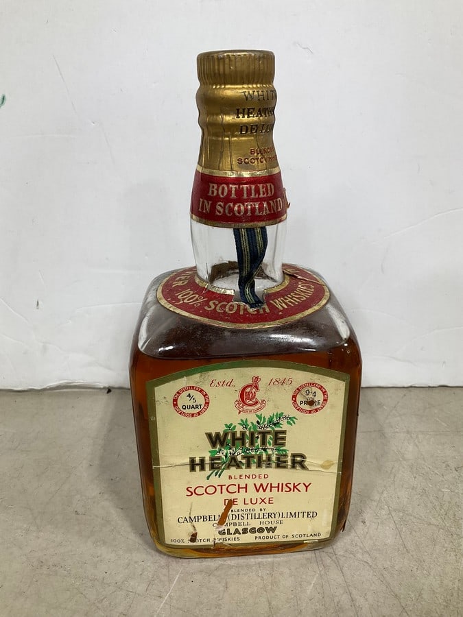 1970's White Heather scotch(750mL): Any contents in bottle is Free; You are bidding on the bottle & unbroken tax stamp