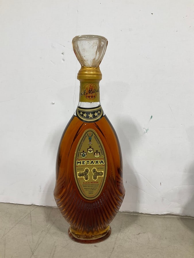 1970's Metaxa five star brandy(750mL): Any contents in bottle is Free; You are bidding on the bottle & unbroken tax stamp