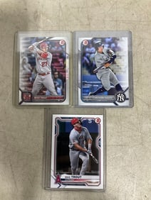 Anthony Volpe and Mike Trout collectible cards in covers