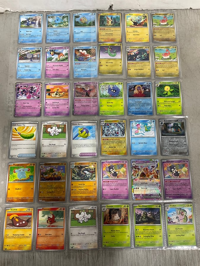 Twilight Masquerade and surging sparks Pokemon cards in collector sheets: Twilight Masquerade and surging sparks Pokemon cards in collector sheets
