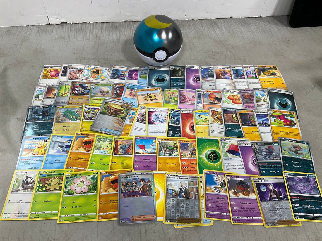 Poke ball and various Pokemon cards: Poke ball and various Pokemon cards