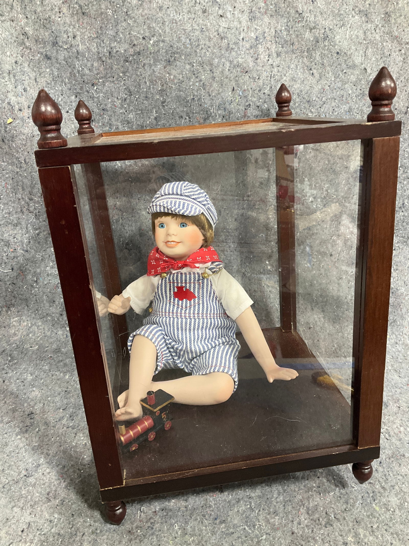 Ashton Drake Galleries Andy the Engineer doll in case(case cracked and damaged on bottom, missing: Ashton Drake Galleries Andy the Engineer doll in case(case cracked and damaged on bottom, missing one leg-10.5in.x10.5in.x15in.)