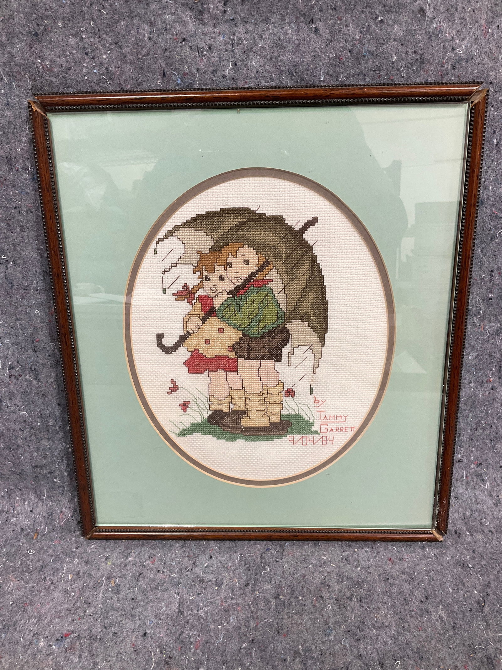 Framed handmade cross stitch hummel by Tammy Garrett(frame damaged-12inx14in) (1 of 1)
