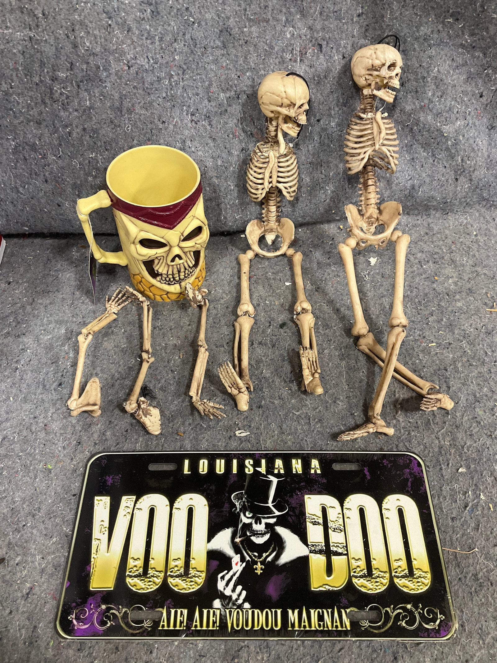 Voodoo license plate, skull mug, and other skeleton decor (1 of 1)