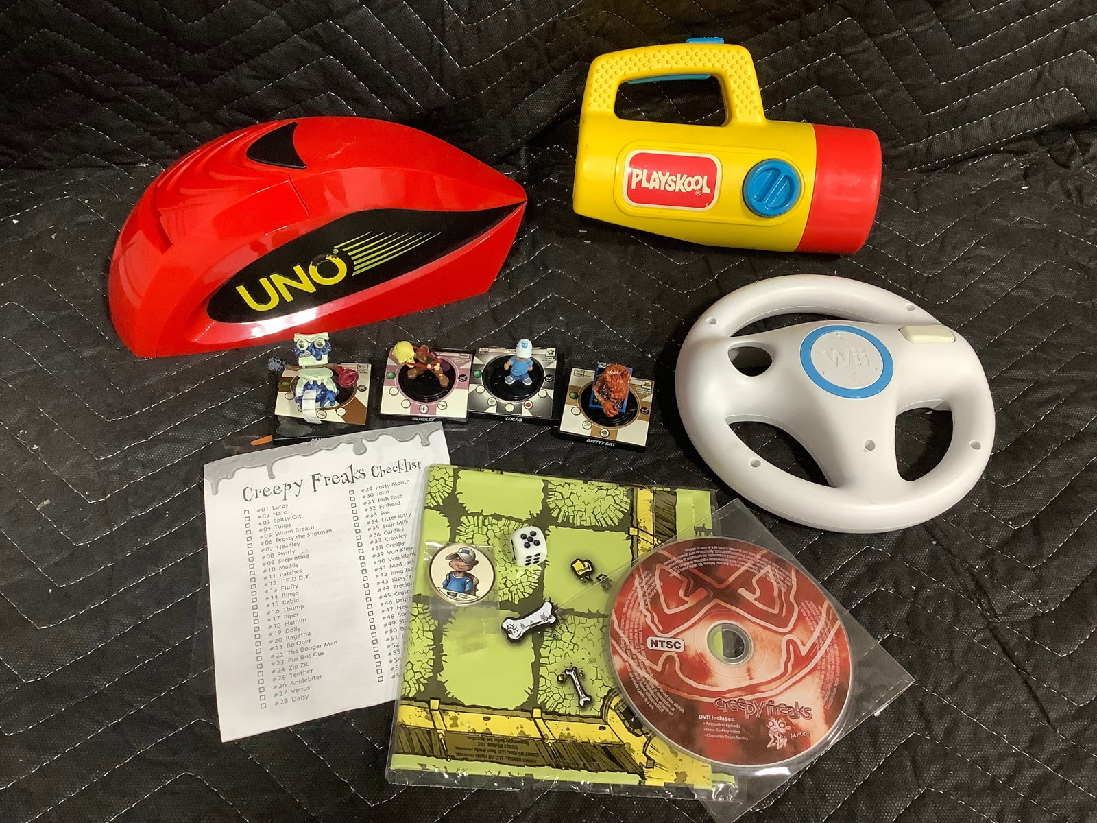 Uno card shooter, Playskool flashlight, creepy freaks game pieces, and more (1 of 1)