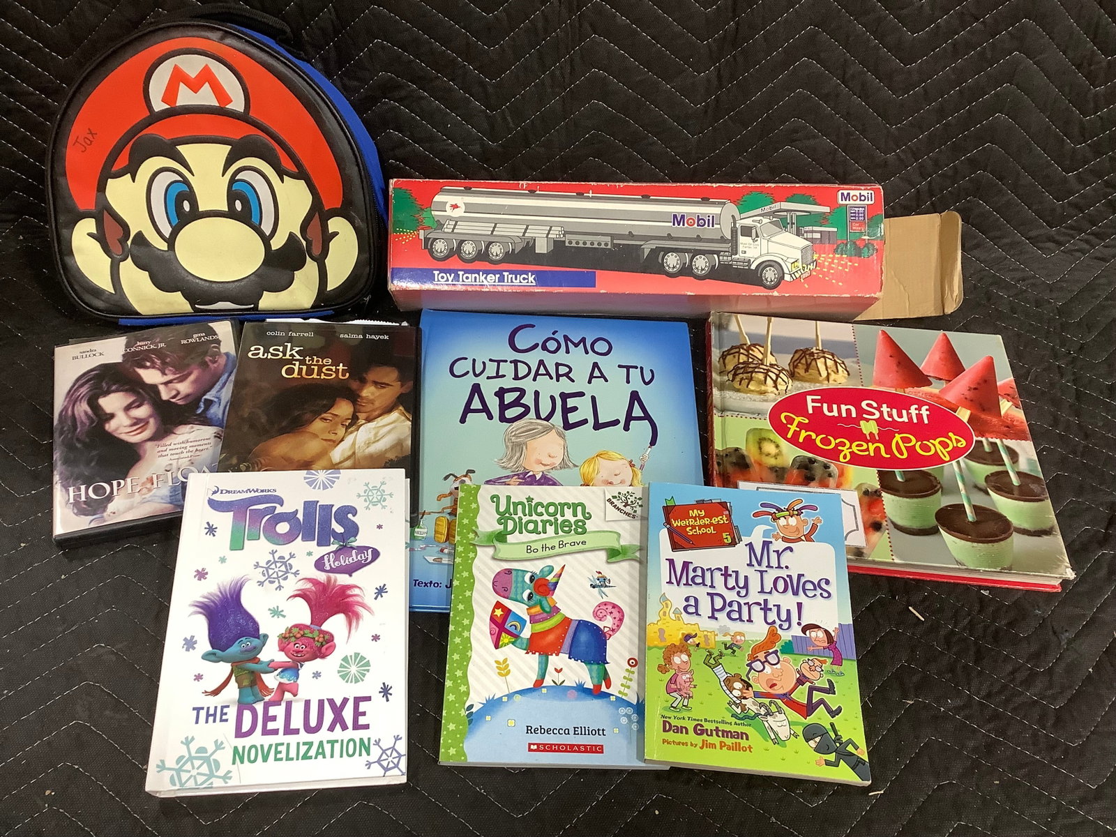 Mobil Toy Tanker truck, various childrens books, and Mario bag (1 of 1)