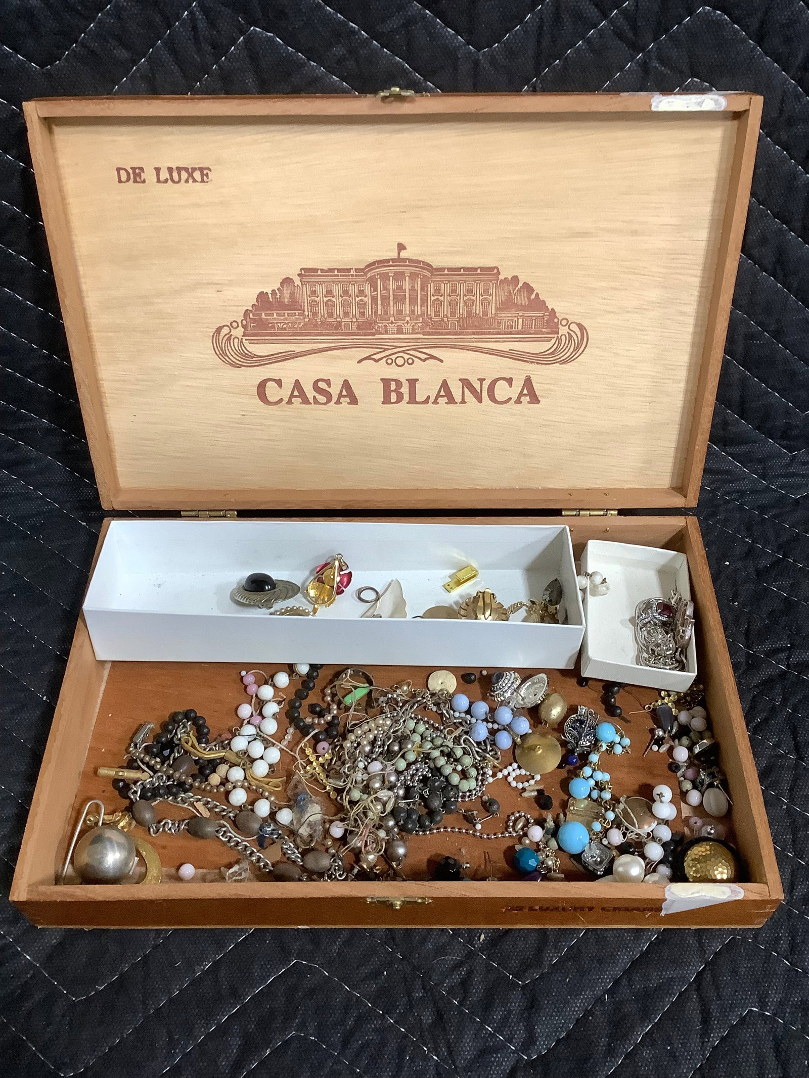 Costume jewelry in vintage cigar box: Costume jewelry in vintage cigar box