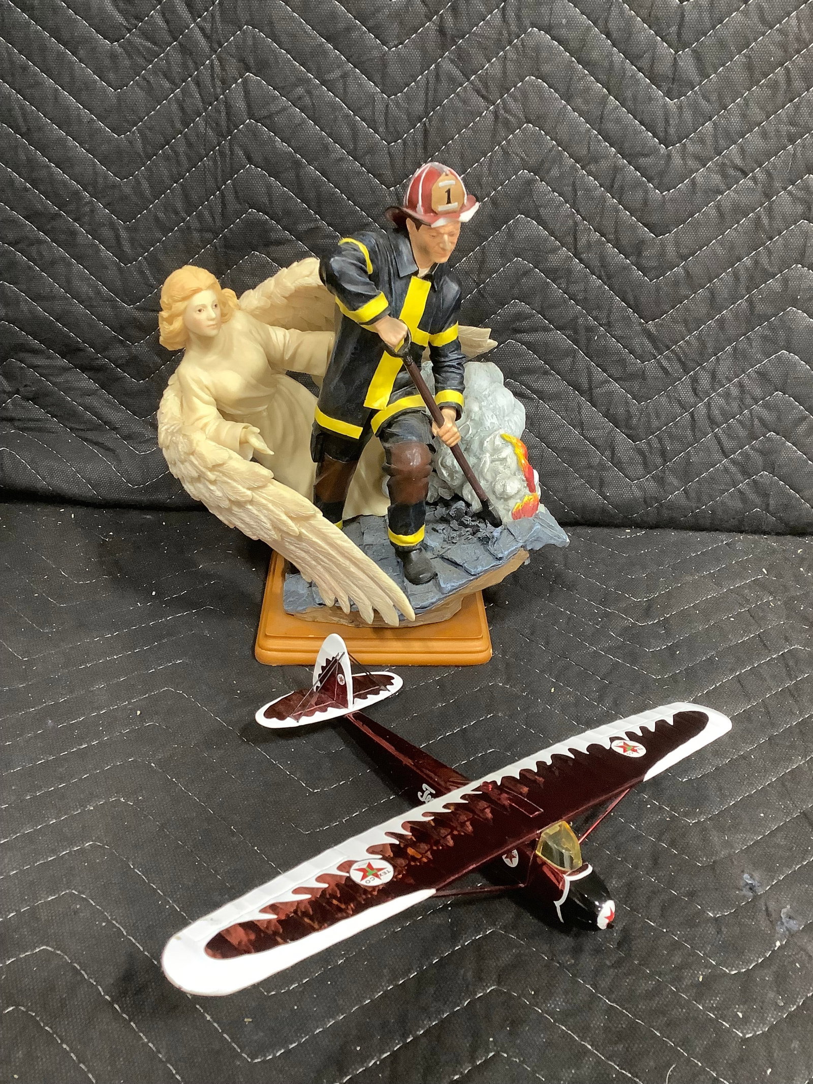 Texaco Eaglet plane and fireman statue(hat chipped-9.5in tall): Texaco Eaglet plane and fireman statue(hat chipped-9.5in tall)