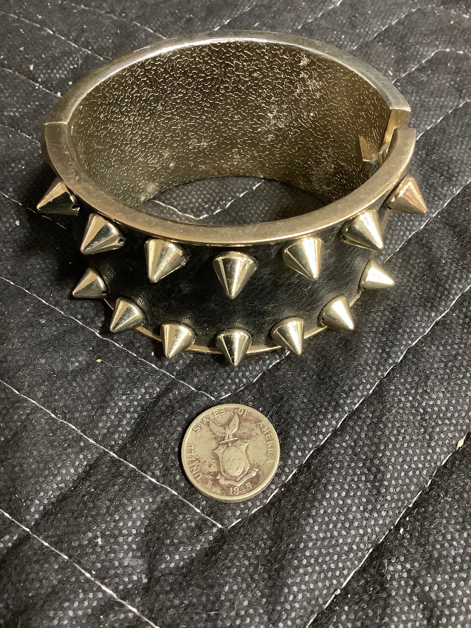 Black spike cuffed bracelet and 1945 coin: Black spike cuffed bracelet and 1945 coin