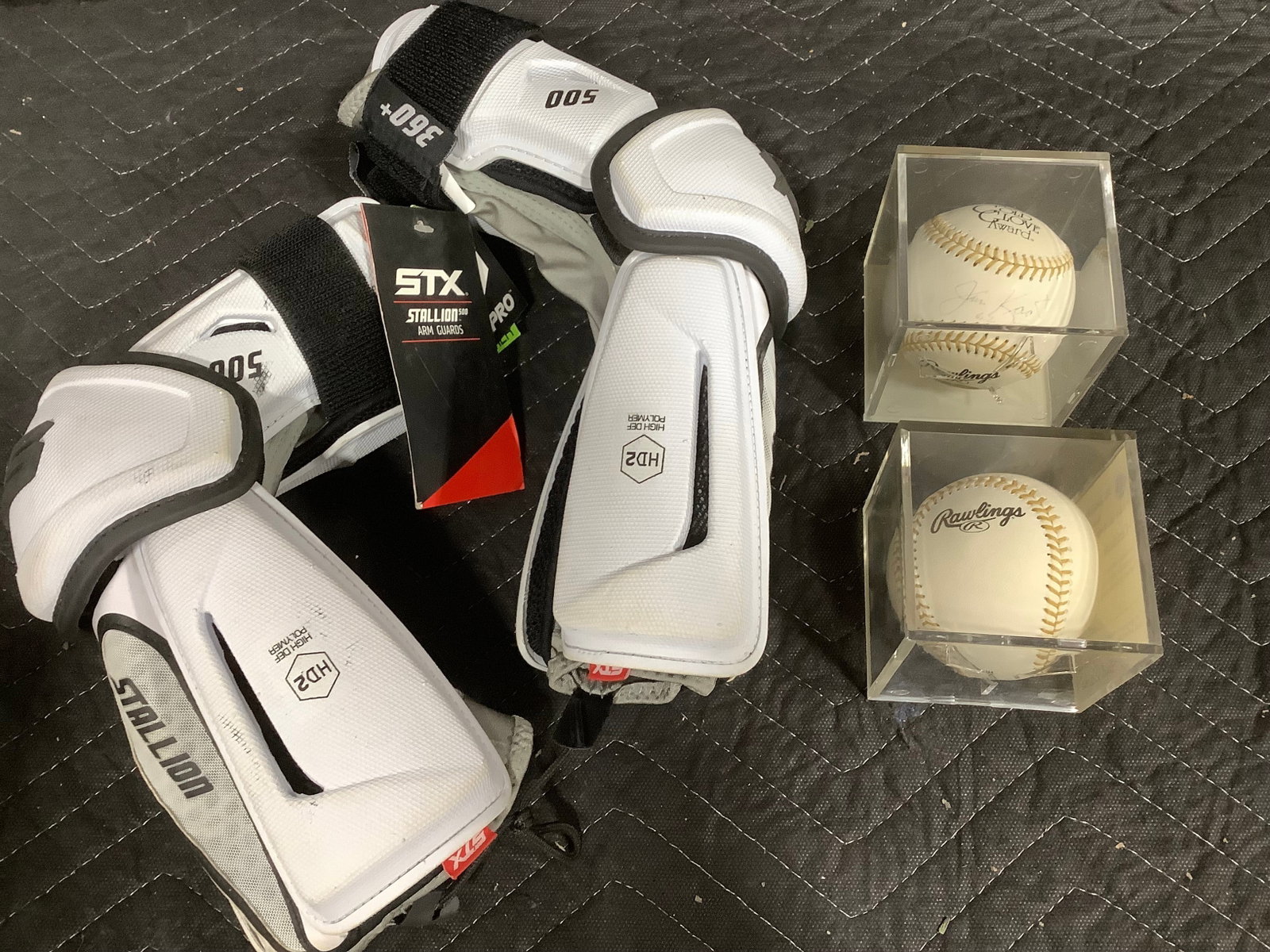 STX arm guards and signed baseballs in display cases (1 of 1)