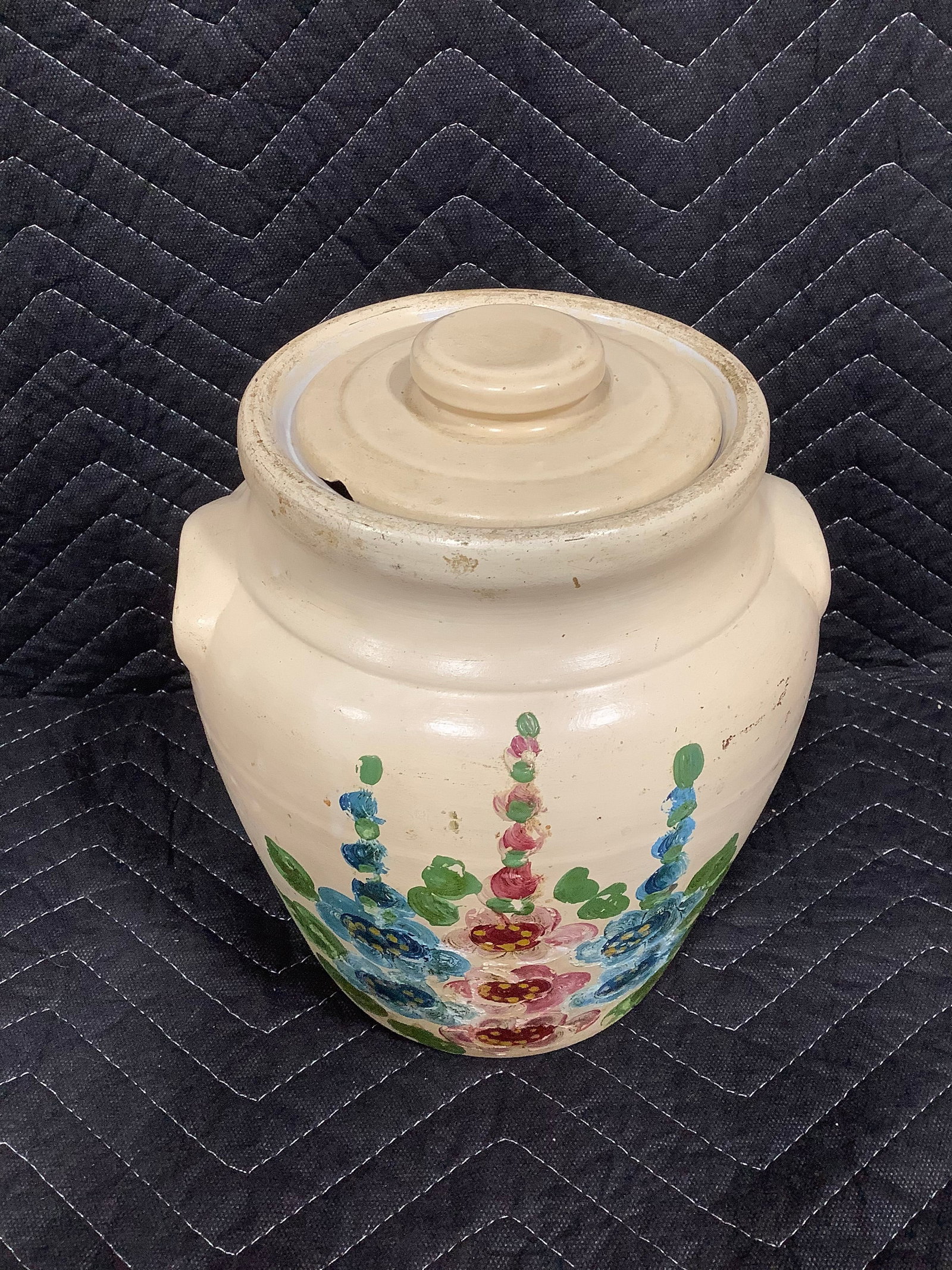 Tan lidded folk art style painted pottery jar: Tan lidded folk art style painted pottery jar