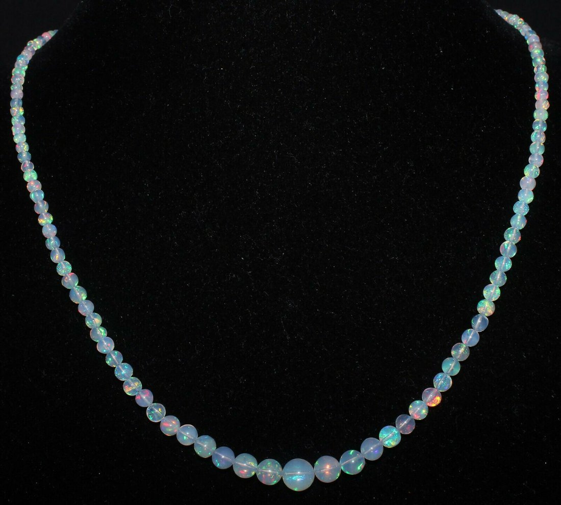 Natural Ethiopian Welo Fire Opal Balls Necklace 2.5-7MM: Cut Grade: Very Good Country of Origin: EthiopiaColor: Multi-ColorCountry/Region of Manufacture: IndiaTransparency: Transparent Natural/Lab-Created: NaturalTreatment: None (No Enhancement) Length: 17I