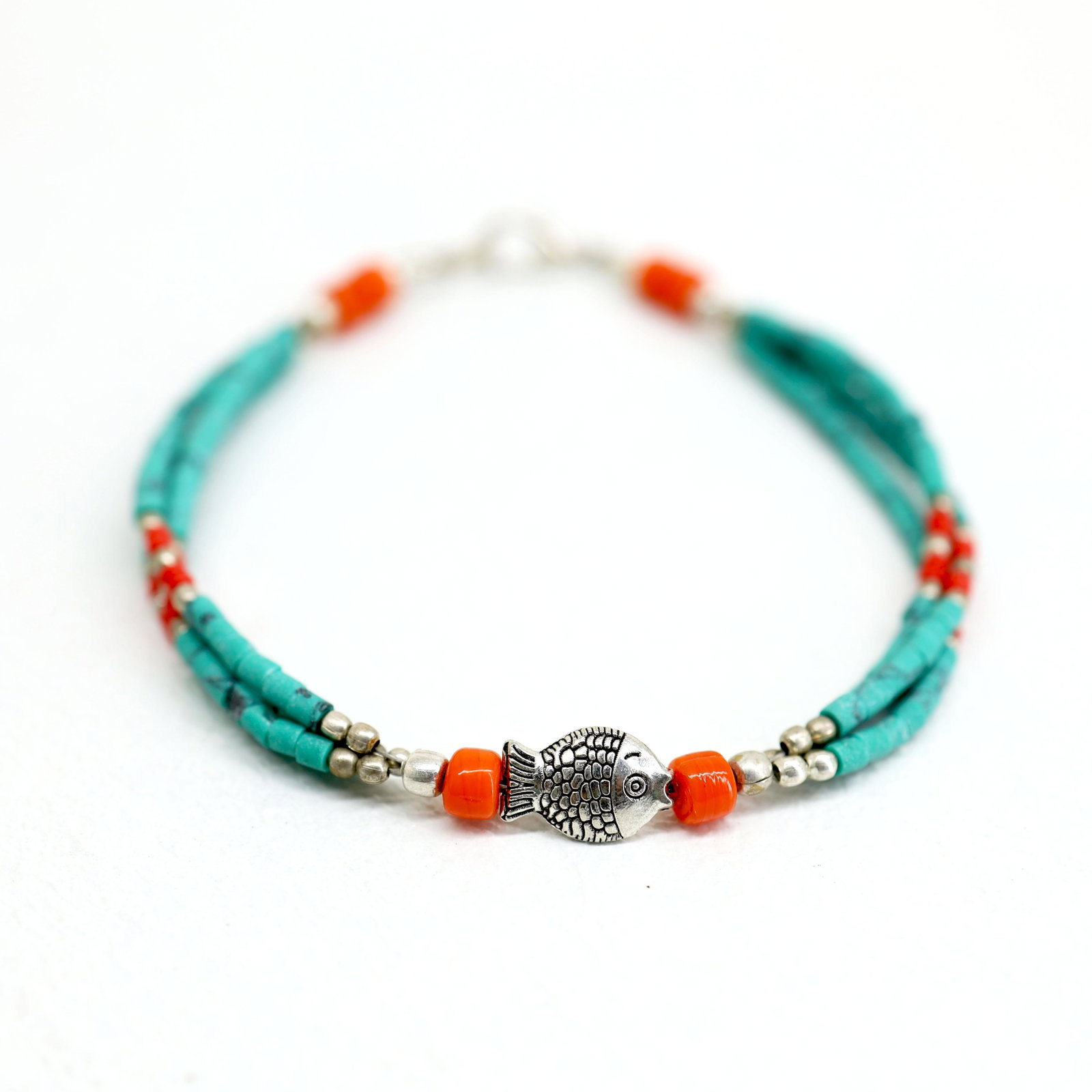 Tibetan Turquoise Handmade Beaded Fish Bracelet: TIBETAN TURQUOISE & CORAL HANDMADE BRACELETWeight: 10 Gram ApproxGemstones: Turquoise & Coral, LapisBrand: HandmadeBracelet Length: 7 to 8 InchCountry/Region of Manufacture: Kathmandu/Nepal