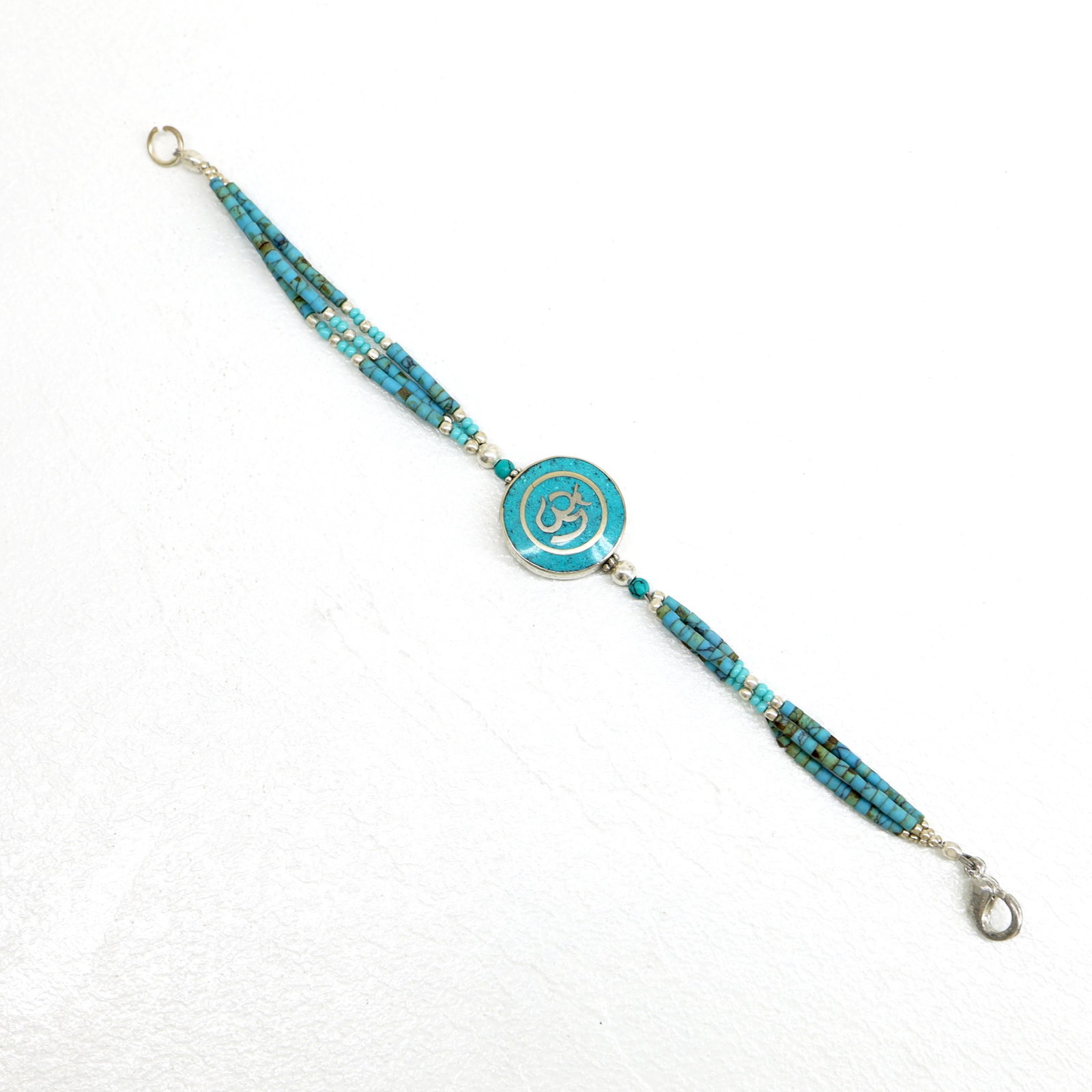 Tibetan Turquoise Handmade OM Pendant Bracelet: TIBETAN TURQUOISE & CORAL HANDMADE BRACELETWeight: 10 Gram ApproxGemstones: Turquoise & Coral, LapisBrand: HandmadeBracelet Length: 7 to 8 InchCountry/Region of Manufacture: Kathmandu/Nepal