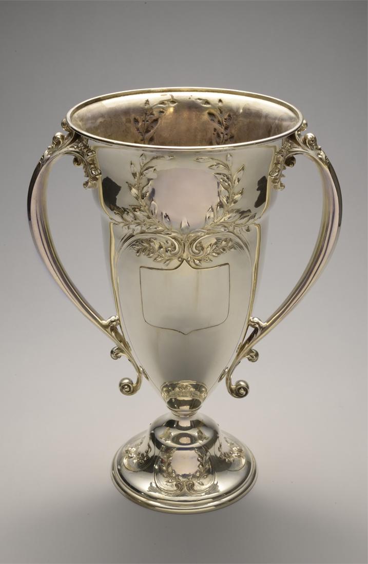 Sterling Silver Chalice: A Sterling silver chalice with two handles, weighing 2074 grams.