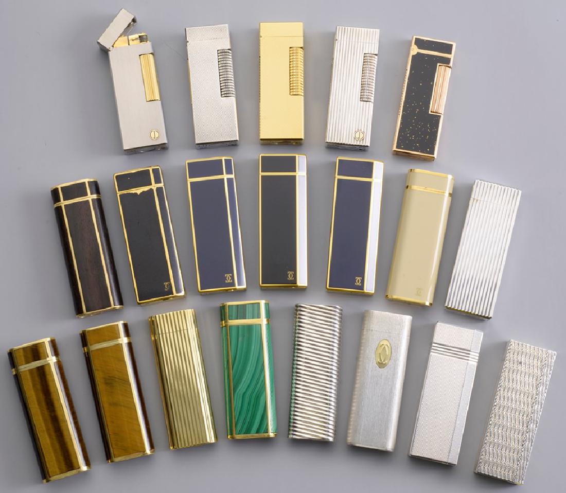 A lot of 21 Vintage Cartier and Dunhill Lighters: There are 15 Cartier Paris lighters, 5 Dunhill lighters, & one bonus lighter. The lighters come in assorted colors & made with materials such as solid 750 grade 18 Carat Gold, Blue Lapice, Black Ename