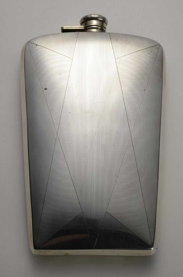 Antique Silver Flask with Geometric engraved Art Deco: This Art Deco designed Flask is engraved with shapes that accentuate the beauty of this tall Flask. Its majesty can be appreciated while sneaking a drink as well as an ornate trinket to be adorned in 