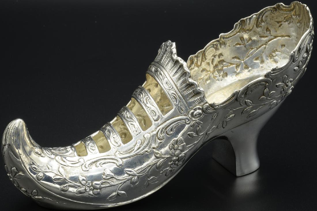 German Sterling Silver Lady's Shoe C 1902: Crafted in Germany Circa 1860, this is a Continental Sterling Silver Shoe. Theodore Hartman imported this German Sterling Lady's Elf Shoe to London England in 1902. The shoe is elegantly decorated wit