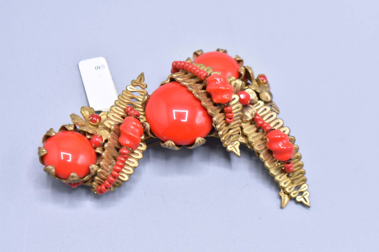 Red Stones Decorated Pin: Pin with gold leaves and a pattern of red spheres