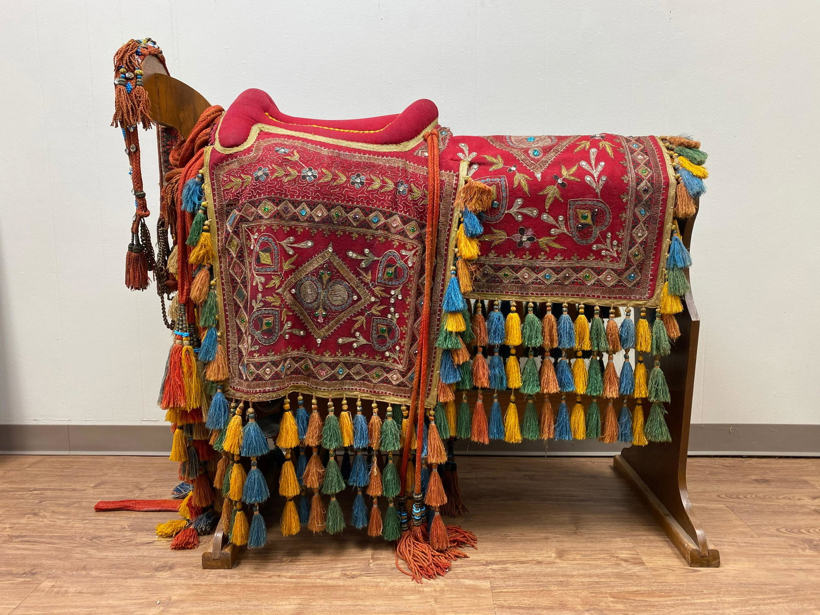 Arabian Cloth Horse Saddle | Jeweled Beaded | Golden: Arabian Red Cloth Horse Saddle | Sewn Decorative Symbols | Embroidered with Gold Thread | Tassel Fringe | Woven Halter | Jeweled Beaded Decoration | Wood Saddle Stand