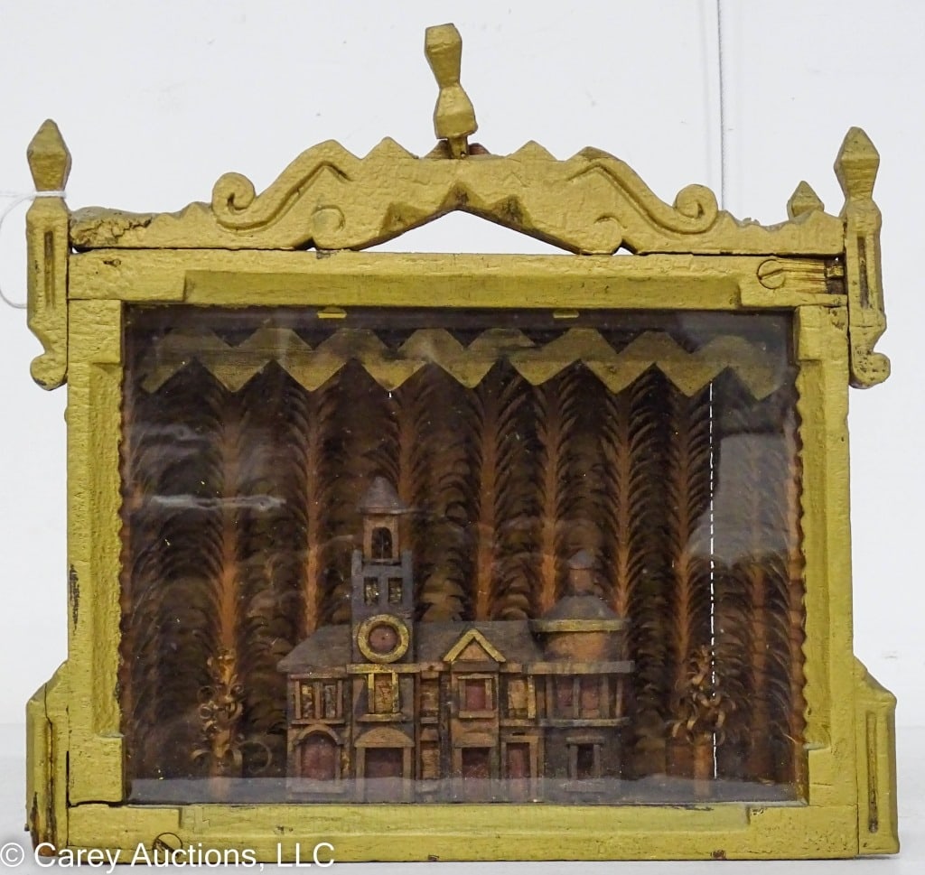 TRAMP ART CARVED DIORAMA DATED 1886: Tramp Art Diorama with a carved church, town hall surrounded by treas building / Has original paint cabinet has old gold paint and 1886 carved in the back / Measures: 10.5"H x 10.75"L x 4"W / Conditio