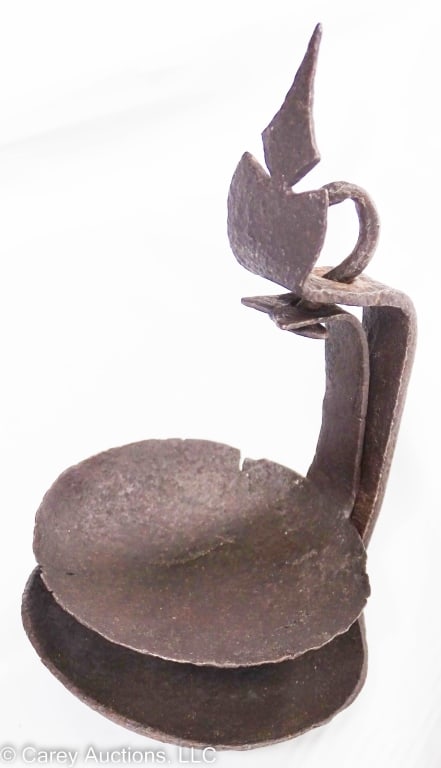 HAND FORGED IRON DOUBLE PAN BETTY LAMP WHALE FAT: Double pan betty lamp, hand forged iron with decorative top. For fat or whale oil, original hanger. / Measures: 6" H x 3.5" D / Condition: Shows wear and rust.