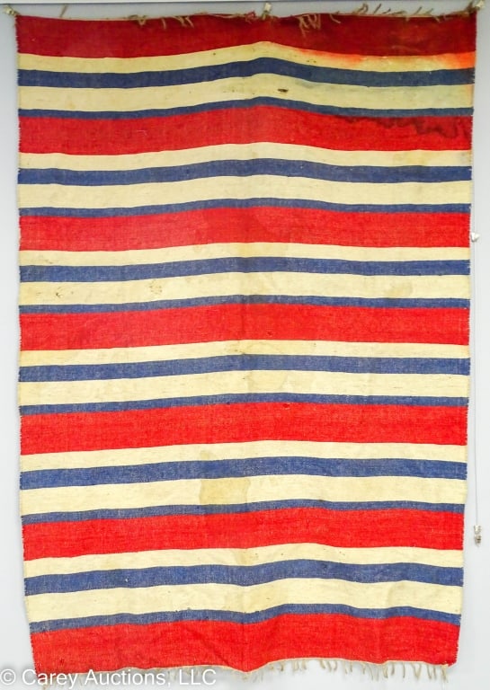 RED WHITE BLUE SOUTHWEST WOVEN RUG OR BLANKET: Handwoven red, white, and blue striped rug or blanket with fringe at the long ends. Possibly Southwestern United States in origin. / Measures: 65.5" x 94" / Condition: Soiling, staining, and scattered