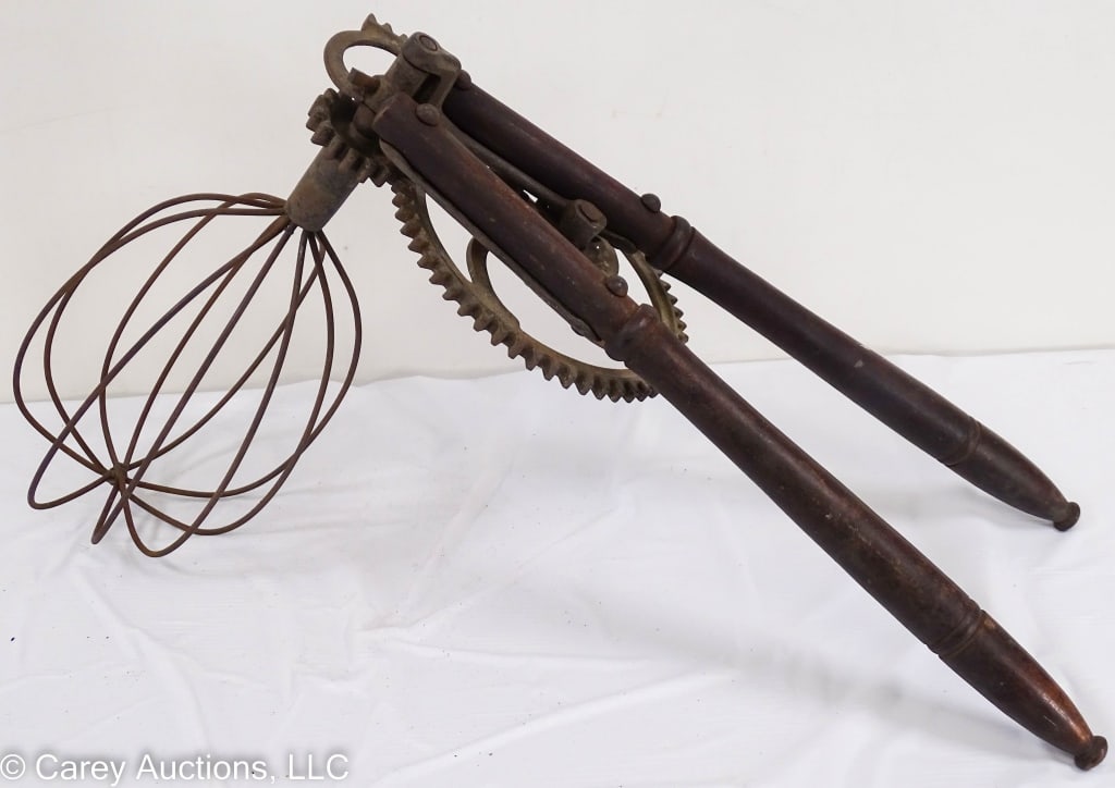 JAQUETTE BROS HUGE 20 INCH CAST IRON EGG BEATER: With wooden handles. / Measures: 14" H x 6.5" diam beater x 20" L / Condition: Nice condition, works smooth and easy. Once piece cast iron cracked near shaft.