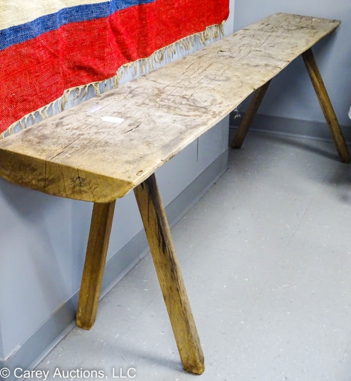 HALF ROUND PLANK BENCH FOR BUTCHERING CROCKS ETC: This bench is made from a half round plank with rough square legs mortised into it. These benches were made for butchering, crocks and other uses. No finish. / Measures: 27" H x 91.5" W x 13.5" D. Pla