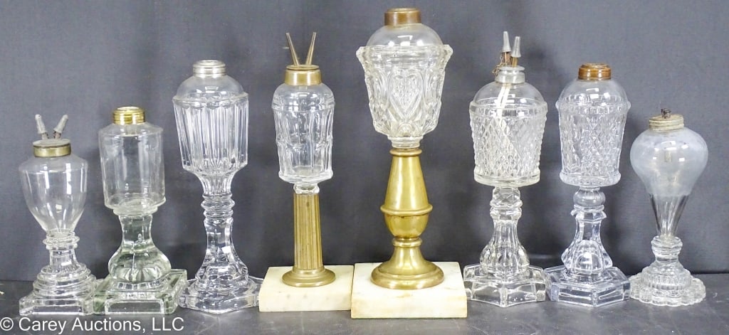 8 19th C WHALE OIL FLUID LAMPS INCL SANDWICH: Early to mid 19th Century fluid whale oil lamps. Includes Boston Sandwich Glass. 2 have marble bases, 4 have pewter on brass burners. The tall marble base lamp has the heart thumbprint pattern by Sand