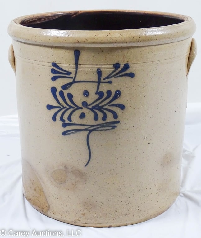STONEWARE 4 GALLON CROCK WITH BLUE FREEHAND: 4 gallon stoneware crock with blue freehand decoration. Handles on sides. Large darker areas from in the firing. / Measures: 11.5" H X 11.5" diam / Condition: Good condition.