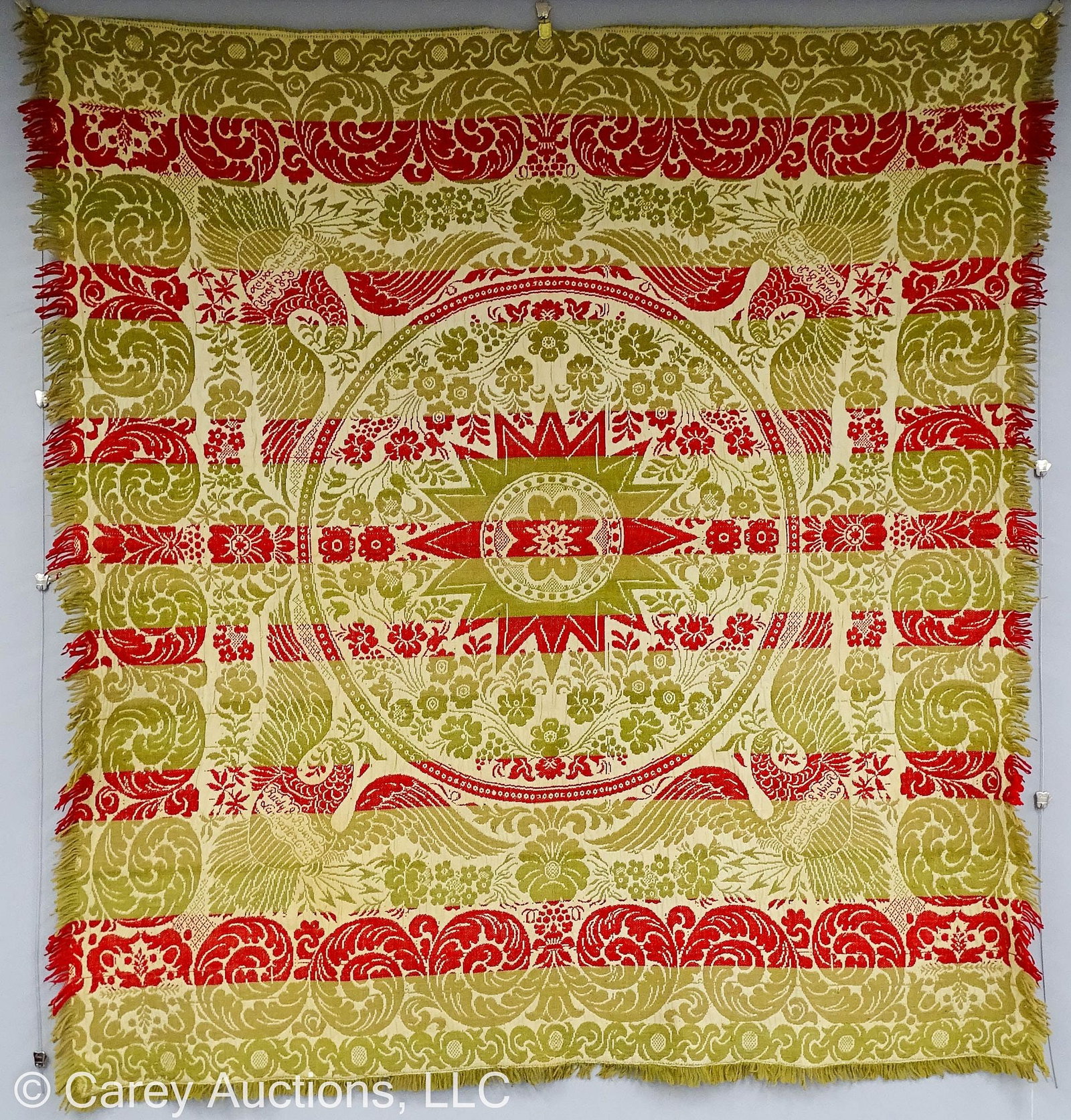 1800s RUDY & BROWN LANCASTER CO PA COVERLET: 2-Color woven coverlet signed [Rudy & Bowman Lancaster Co Pa]; Red, green & natural with acanthus border, edges with signed shield bodies in each corner bordered by roses and foliage; ce