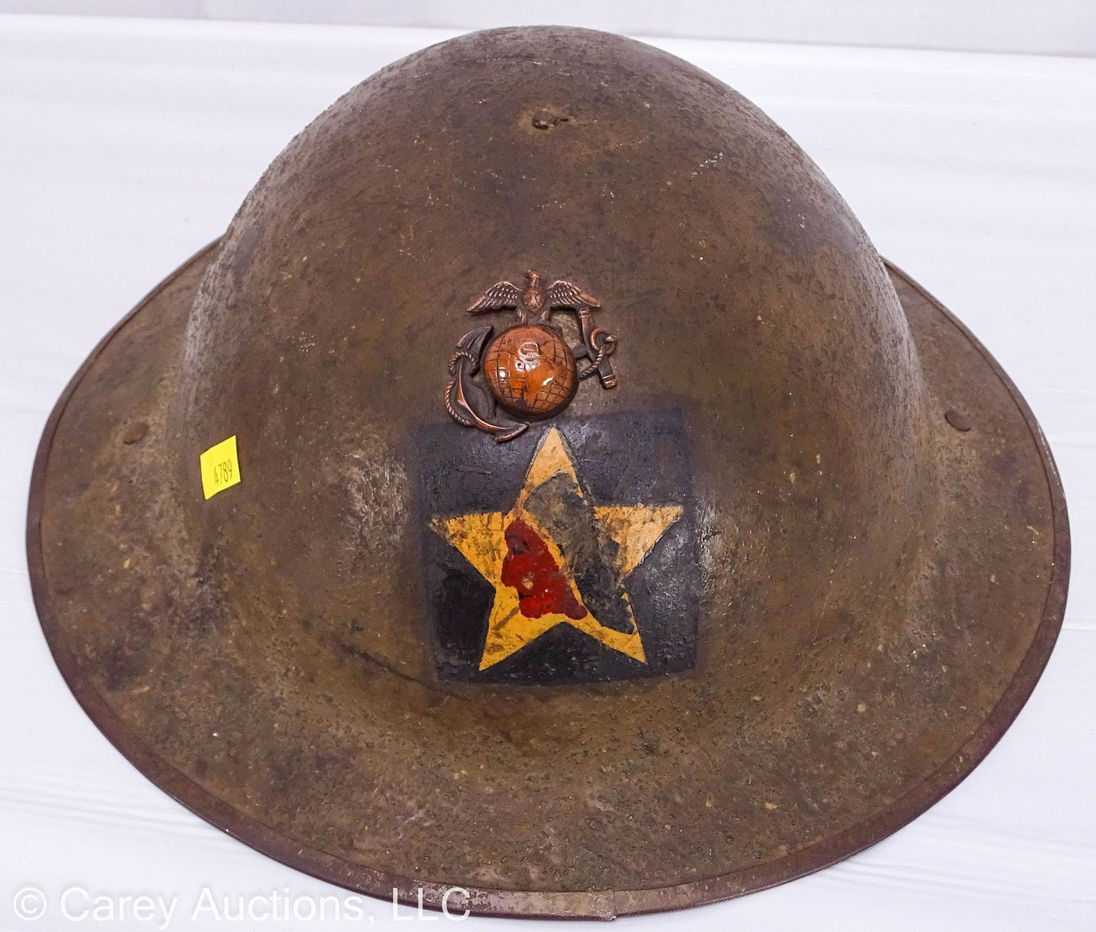 WWI US MARINE CORPS M1917 COMBAT HELMET: Original World War I doughboy US Marine Corps combat helmet M1917; this was the first protective helmet adopted by the United States during WWI; this has a painted purple square with a painted Indian 