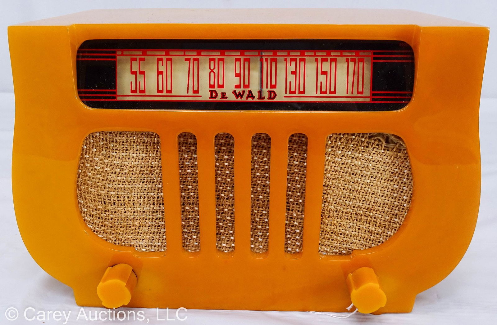 DEWALD MODEL A501 HARP CATALIN RADIO IN BUTTERSCOTCH: A DeWald Harp radio model A501 in butterscotch Bakelite body with matching butterscotch pinwheel knobs; partial model ID tag on bottom // Measures: 6.5"H x 9.75"W x 5.75"D // Condition: