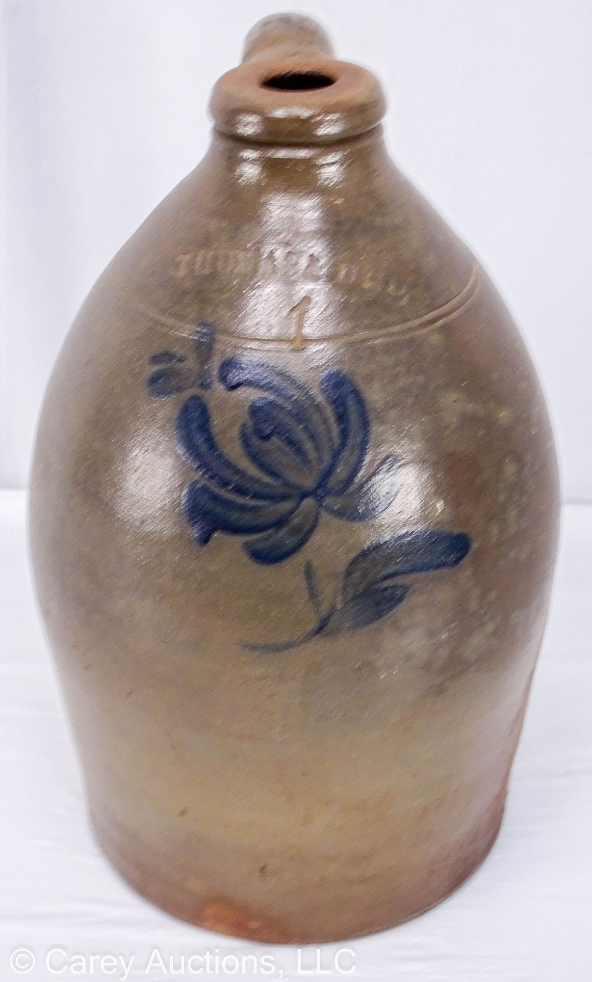 1 GALLON THOMAS & BRO HUNTINGDON PA DECORATED STONEWARE JUG: Circa 1870, Huntingdon County Pa. Tooled shoulder and cobalt tulip foliate decoration. With maker's stamp [Thomas & Bro. Huntingdon Pa] and impressed [1]. // 