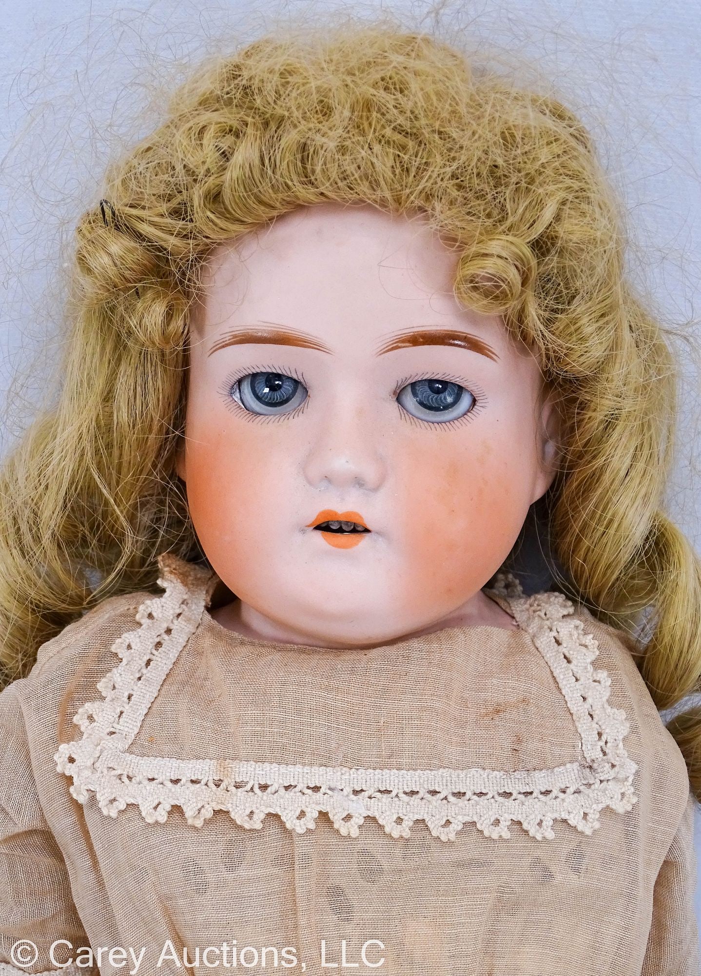 26" ANTIQUE GERMAN BISQUE HEAD DOLL: Blue sleepy eyes, blonde mohair wig, open mouth with teeth, painted eyebrows & lashes, legs are joined, arms are not, kid leather boots and period clothing // Measures: 26" long // Condition: