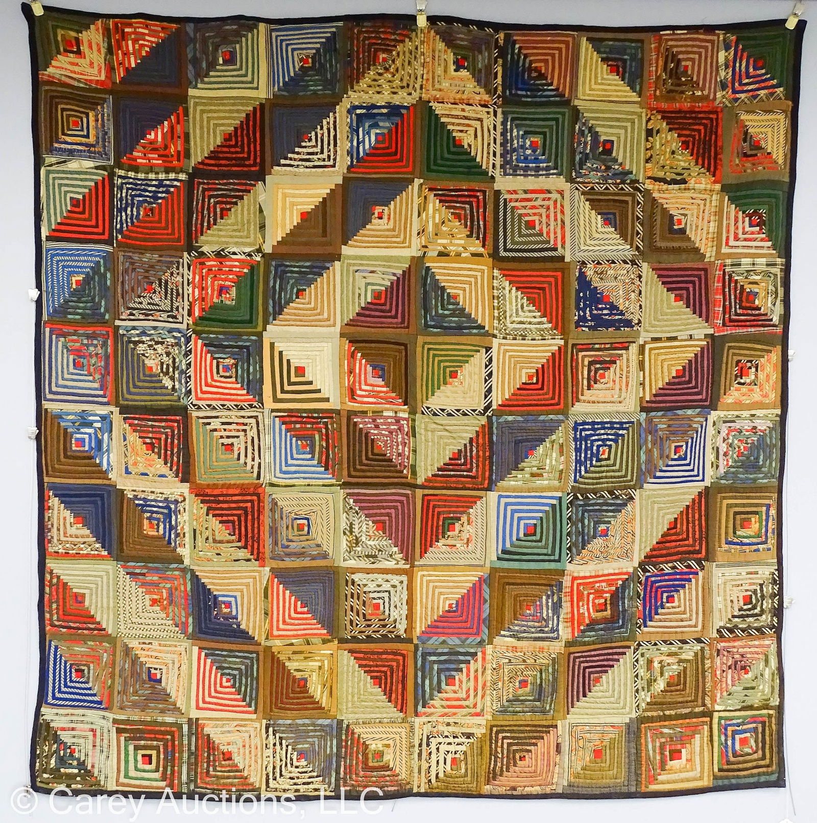 LOG CABIN COURTHOUSE STEPS BEDCOVER: 1800's hand pieced dec cover; assorted fabrics with later added velcro strap that could be removed; Reverse is quilted in red and black threads with red and black pieced fabric // Measures: 7