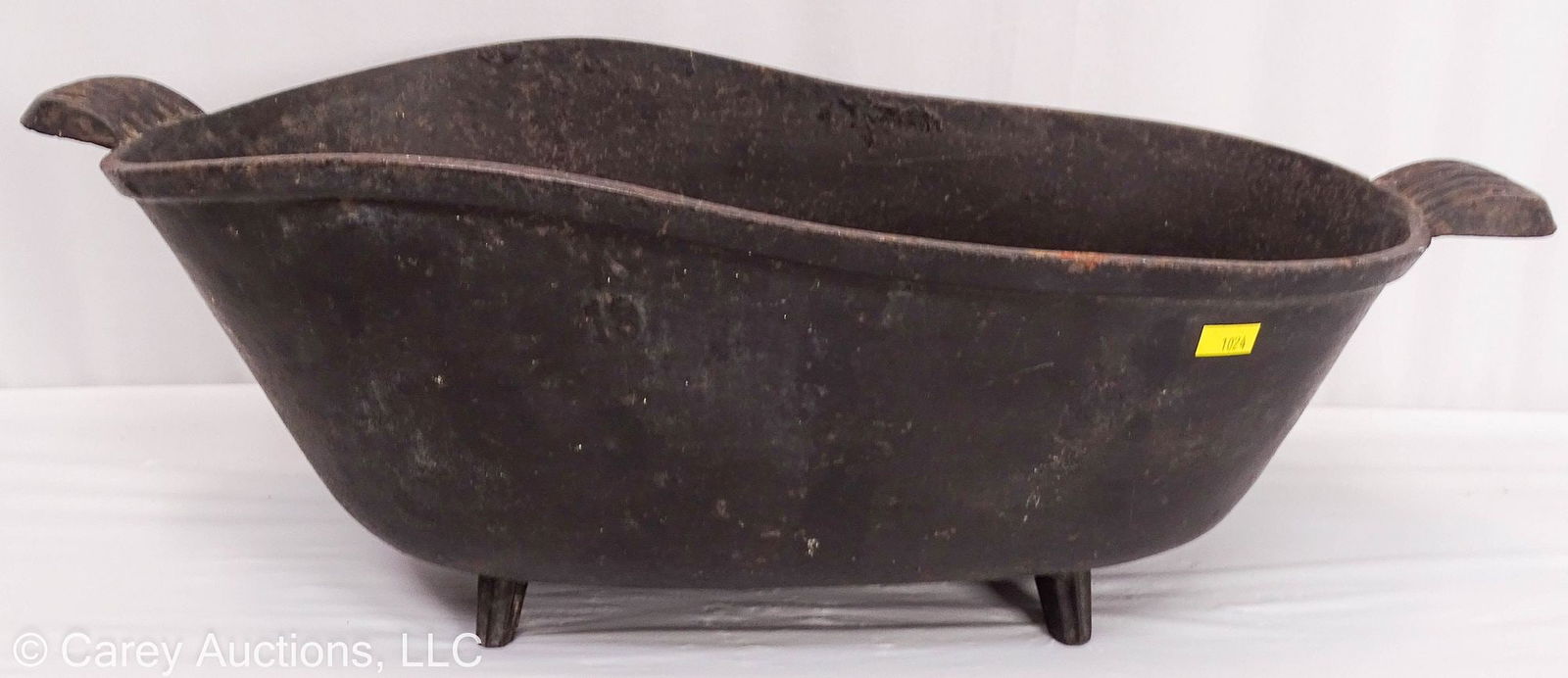 ANTIQUE VICTORIAN CAST IRON MINIATURE TUB: Cast iron vessel with ribbed handles and feet, shaped like a miniature bath tub. May have been used as a meat boiler. //Dimensions; 9"h x 23"w x 10.5"d //Condition: Rusting to interior