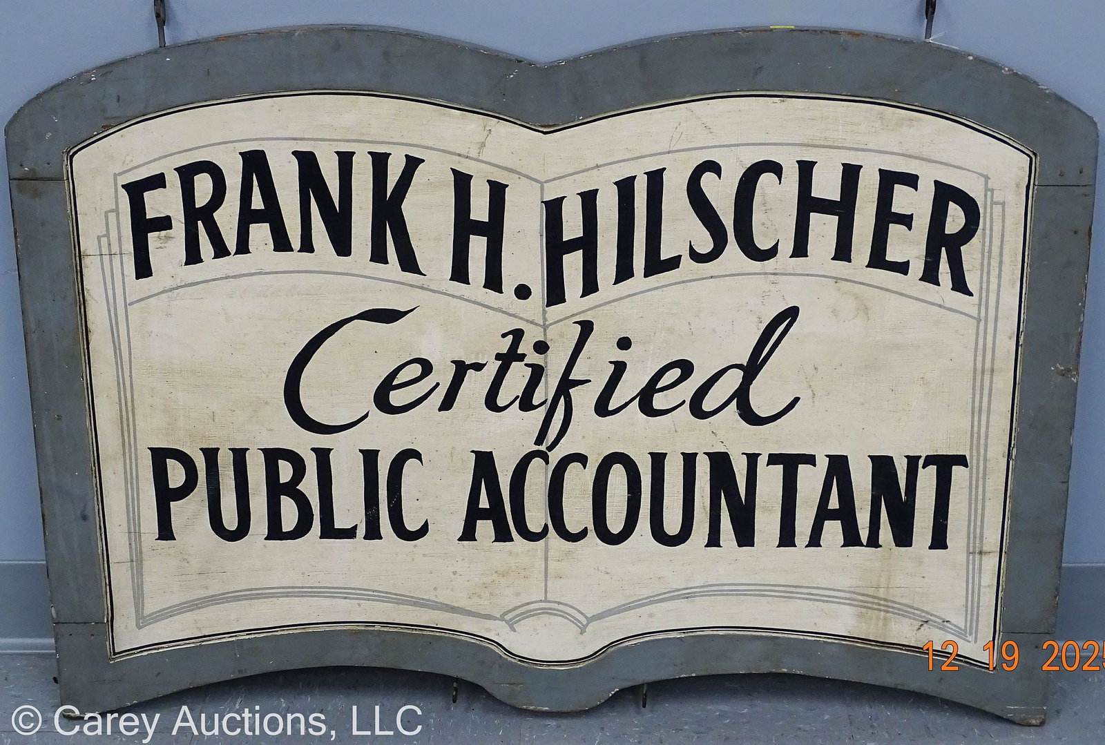 FRANK HILSCHER SUNBURY PA WOODEN SIGN: Vintage 1950-60's Wooden sign advertising Frank H Hilscher Certified Public Accountant; Sign is in the shape of an open book, metal hanging hooks top and bottom // Measures: 24"H x 26"W 
