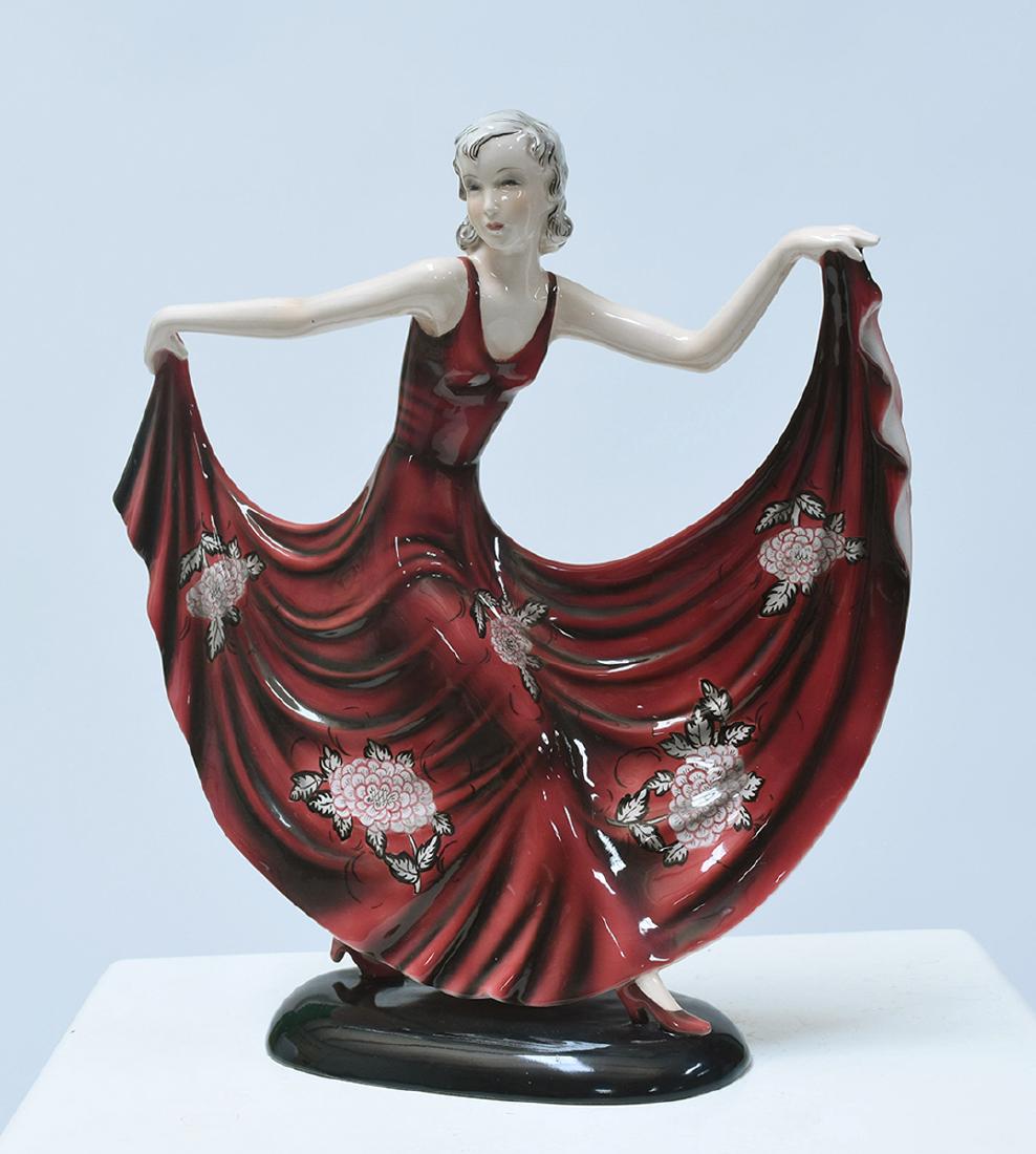 Goldscheider Art Deco figure of dancing woman : Goldscheider Art Deco figure of dancing woman in outstretched red dress with floral pattern, impressed “Goldscheider Wien, Made in Austria- Dakon”, 7961-35-19. 13.5”H. x 12.5”W