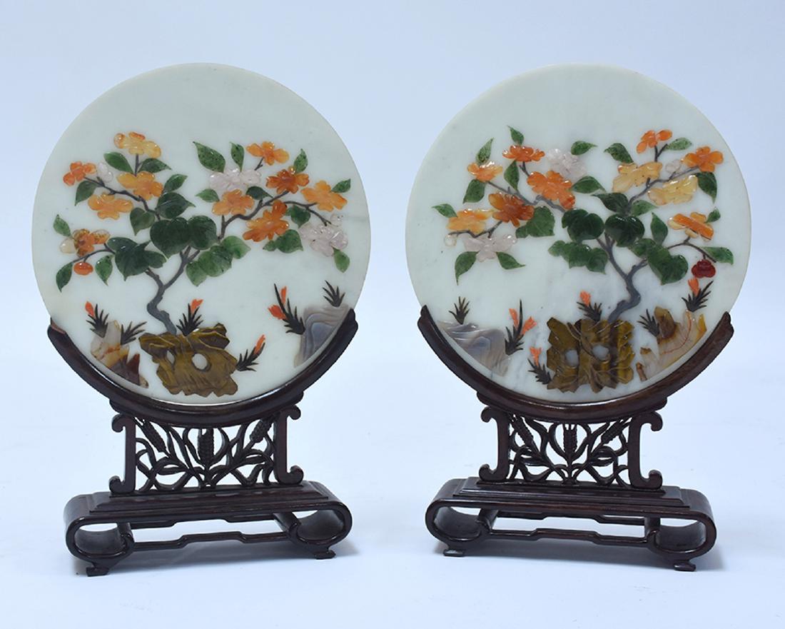 Good pair of Chinese hardstone table screens: Good pair of Chinese hardstone table screens, round stone plaque with jade, carnelian, rose quartz, tigers eye, agate, and other materials. Plaques sit in carved rosewood frames, 10.75”Dia., 16&