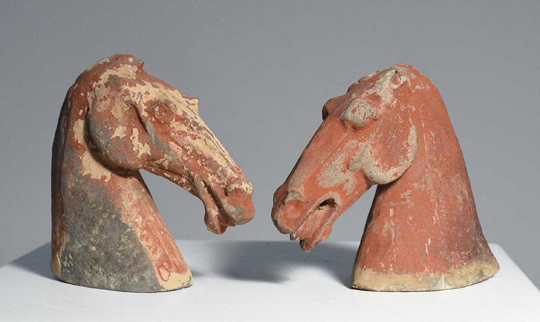 Two Han Dynasty pottery horse heads: Two Han Dynasty pottery horse heads. Retaining much of original red pigment, mouth slightly open. Original bills of sale from Anthony Gray London 1985, £1700:, the other from Charlott