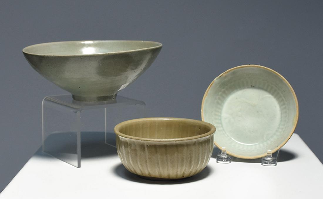 Three celadon bowls: Three celadon bowls. 1- 7” x 2.75”H. with low relief flowers; 1- 4 7/8” with low relief flowers in bottom, ribs come up inside