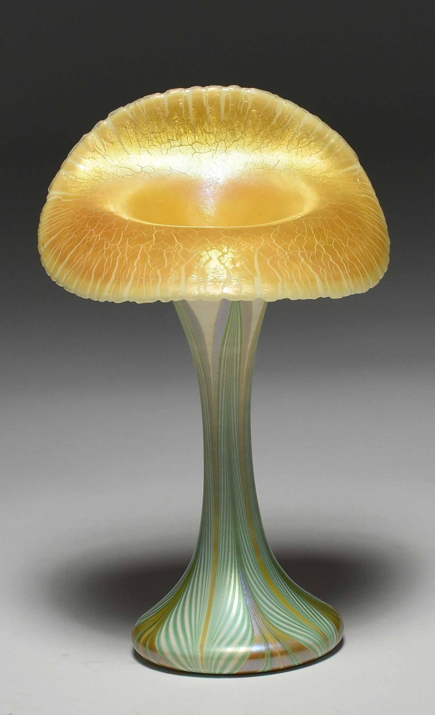 Quezal Jack-in-the-Pulpit Art Glass Vase: Quezal Jack-in-the-Pulpit art glass vase with gold interior and green, cream and gold striped exterior. Signed on bottom “Quezal”. 6.5”H x 4” dia. 0.5 lbs.