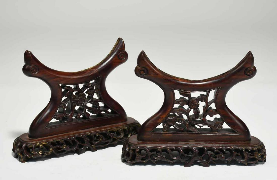 Pair of Chinese Rosewood Disc Stands: Pair of Chinese rosewood disc stands with pierced carving in floral and foliate design, tops bolted to bottoms, traces of old gilding. 12”H L x 9”H . 4.5 lbs.