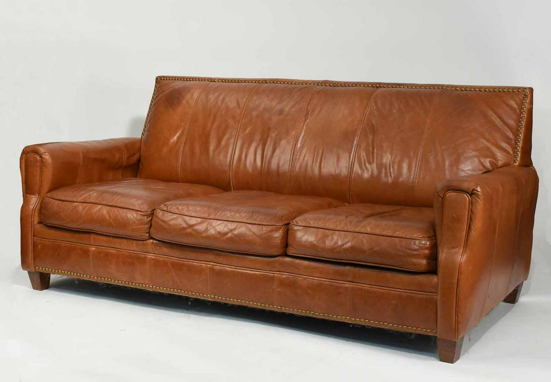 Brown Studded Leather Three-Cushion Sofa: Brown caramel leather three-cushion sofa, with brass studs, 82”L x 36”H x 37”D.