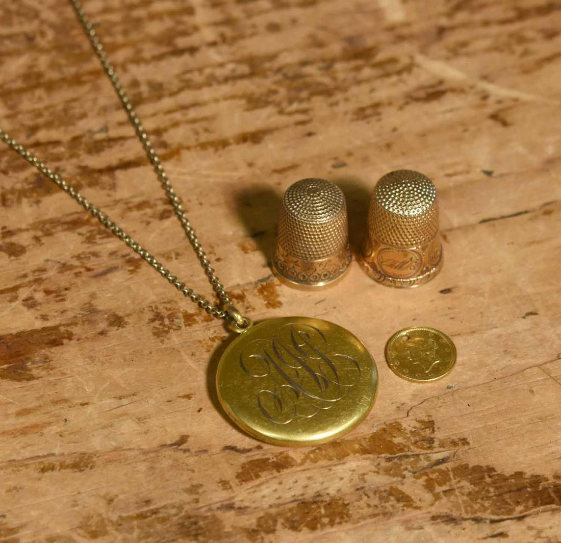 Antique Gold Items: Two 10k gold thimbles with a 10k gold locket and chain, with a 1 dollar gold coin, 18 grams.